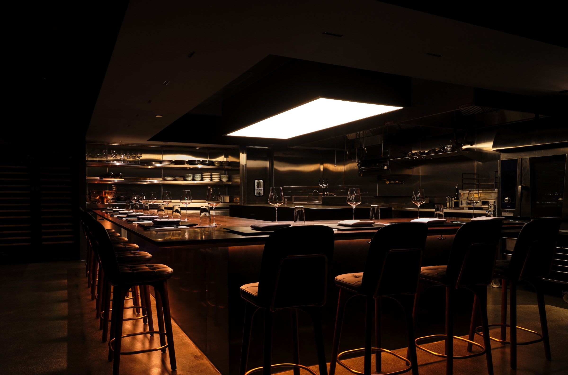 Tasting counter at Corridor 109 in dim lighting with a rectangular counter