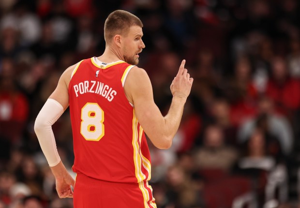The Atlanta Hawks' Kristaps Porziņģis (8) holds a finer up after sinking a basket in the second quarter during a game against the Chicago Bulls, Monday, Oct. 27, 2025, at the United Center in Chicago. (Dominic Di Palermo/Chicago Tribune)