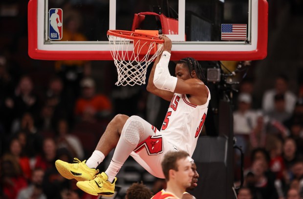 Chicago Bulls' Isaac Okoro (35) hangs on the rim after getting fouled while dunking the ball in the third quarter during a game against the Atlanta Hawks, Monday, Oct. 27, 2025, at the United Center in Chicago. (Dominic Di Palermo/Chicago Tribune)