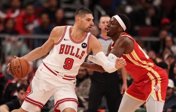 Chicago Bulls center Nikola Vučević (9) drives the lane against Atlanta Hawks' Onyeka Okongwu (17) in the third quarter, Monday, Oct. 27, 2025, at the United Center in Chicago. (Dominic Di Palermo/Chicago Tribune)