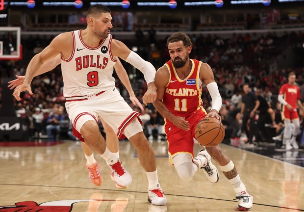 Atlanta Hawks guard Trae Young (11) drives the lane against Chicago Bulls center Nikola Vučević (9) in the third quarter during a game, Monday, Oct. 27, 2025, at the United Center in Chicago. (Dominic Di Palermo/Chicago Tribune)