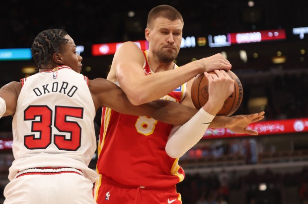 Atlanta Hawks' Kristaps Porziņģis (8) tries to keep the ball away from Chicago Bulls' Isaac Okoro (35)in the fourth quarter during a game, Monday, Oct. 27, 2025, at the United Center in Chicago. (Dominic Di Palermo/Chicago Tribune)