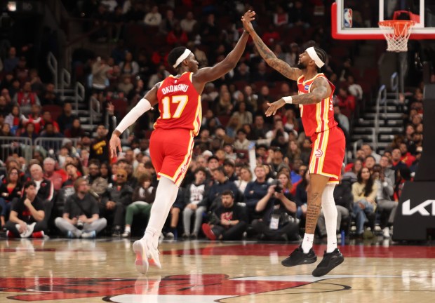 Atlanta Hawks' Onyeka Okongwu (17) and Atlanta Hawks guard Nickeil Alexander-Walker (7) celebrate a basket in the fourth quarter during a game against the Chicago Bulls, Monday, Oct. 27, 2025, at the United Center in Chicago. (Dominic Di Palermo/Chicago Tribune)