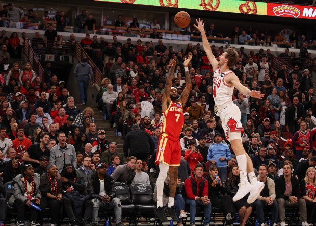 Atlanta Hawks guard Nickeil Alexander-Walker (7) makes a three-point field goal over Chicago Bulls forward Matas Buzelis (14) in the fourth quarter during a game, Monday, Oct. 27, 2025, at the United Center in Chicago. (Dominic Di Palermo/Chicago Tribune)