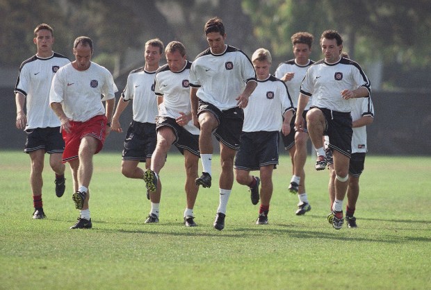 The Chicago Fire and head coach Bob Bradley, second from left, warm up before practice at Loyola Marymount University in Los Angeles, on Oct. 23, 1998. (Nick Ut/AP)