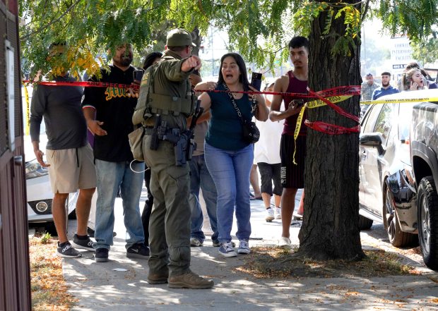 Elizabeth Ruiz pleads with a U.S. Border Patrol agent for...