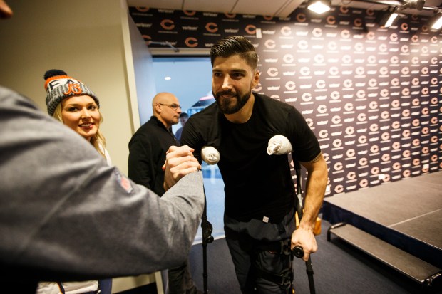 Chicago Bears tight end Zach Miller, right, greets a supporter on Dec. 11, 2017, after a news conference at Halas Hall in Lake Forest and his first media availability since suffering a severe left leg injury on Oct. 29, 2017, against the New Orleans Saints. (Chris Walker/Chicago Tribune)