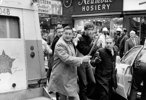 Chicago police and protesters clash at LaSalle and Madison streets on Oct. 11, 1969, during a Students for a Democratic Society (SDS) march in Chicago. (Walter Kale/Chicago Tribune)