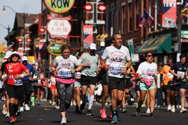Participants run through Chinatown during the Chicago Marathon on Oct. 13, 2024. (Eileen T. Meslar/Chicago Tribune)
