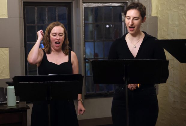Artistic Director Carling FitzSimmons, left, and Alana Grossman, sing during La Caccina's rehearsal for their fall concert, "Weird Sisters," on Oct. 6, 2025. FitzSimmons is one of the original members of the group when it was founded in 2011. (Anastasia Busby/for the Chicago Tribune)