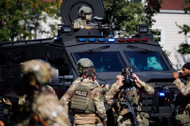 Members of the community and activists protest federal officers near...