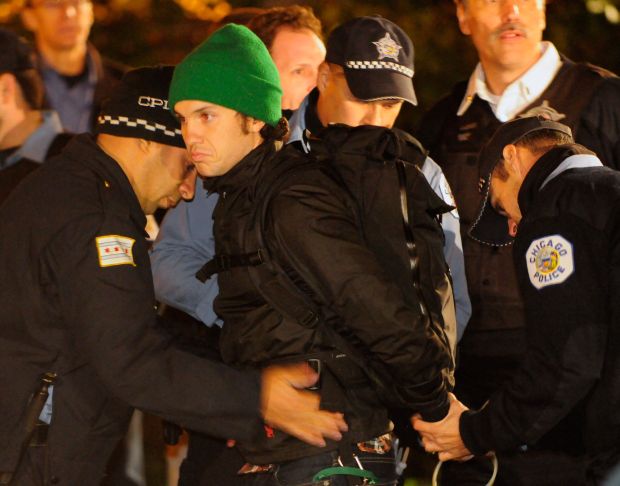 An Occupy Chicago protester is arrested by Chicago police in Congress Plaza early on Oct. 16. 2011. (Reid Compton/for the Chicago Tribune)
