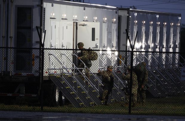 Members of the Texas National Guard assemble at the Army...