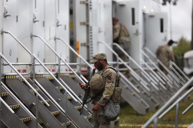 Members of the Texas National Guard assemble at the Army...