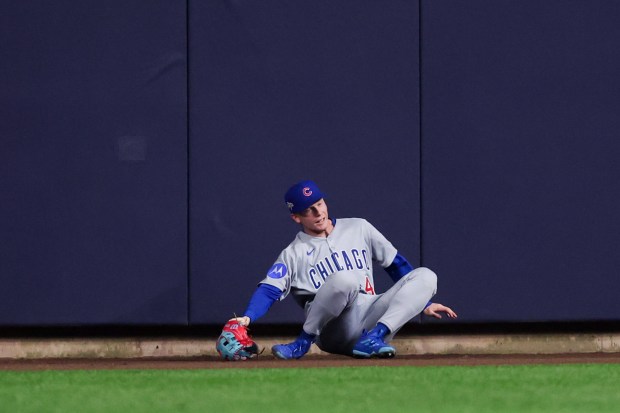 Chicago Cubs outfielder Pete Crow-Armstrong (4) falls after trying to catch a three-run homer from Milwaukee Brewers outfielder Jackson Chourio (11) during the fourth inning in Game 2 of the NL Division Series Monday Oct. 6, 2025, in Milwaukee. (Armando L. Sanchez/Chicago Tribune)