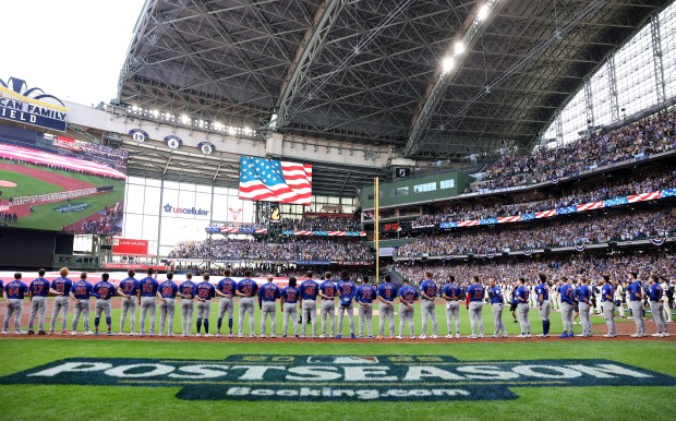 The Chicago Cubs stands for the national anthem before the start of the NL Division Series Game 1 against the Milwaukee Brewers at American Family Field in Milwaukee on Oct. 4, 2025. (Chris Sweda/Chicago Tribune)