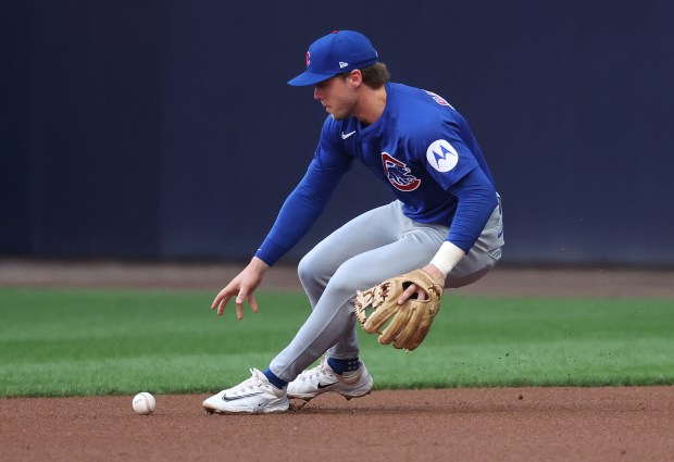 Chicago Cubs second baseman Nico Hoerner (2) picks up the ball after committing an error on a grounder in the first inning of the NL Division Series Game 1 against the Milwaukee Brewers at American Family Field in Milwaukee on Oct. 4, 2025. (Chris Sweda/Chicago Tribune)