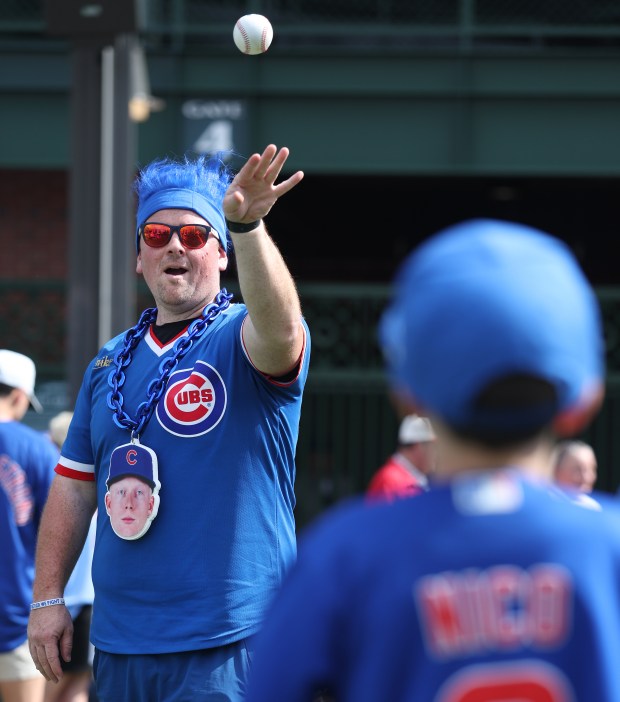 Pete Crow-Armstrong fan Ryan Denk, of Caledonia, plays catch outside of Wrigley Field in Chicago before Game 2 of the NL wild-card series between the Cubs and the San Diego Padres on Oct. 1, 2025. (Chris Sweda/Chicago Tribune)