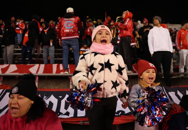 Chicago Fire fans Koraline Rodriguez (cq), 8, and her sister Shelby (cq), 3, cheer before the Fire's Eastern Conference wild-card playoff game against Orlando City at SeatGeek Stadium in Bridgeview on Oct. 22, 2025. (Chris Sweda/Chicago Tribune)