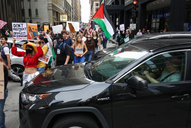 Demonstrators march through stopped traffic in the Loop during the "No Kings" march after a rally at Butler Field Saturday, Oct. 18, 2025, in Chicago. (John J. Kim/Chicago Tribune)