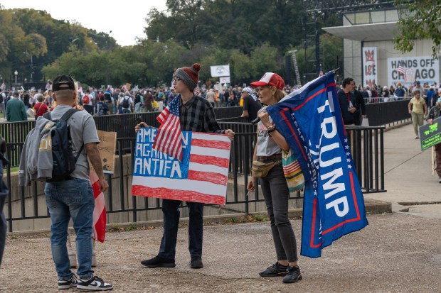 Supporters of President Donald Trump stand at the entrance to Butler Field in Grant Park ahead of the "No Kings" rally on Oct. 18, 2025, in Chicago. (Peter Tsai/Chicago Tribune)
