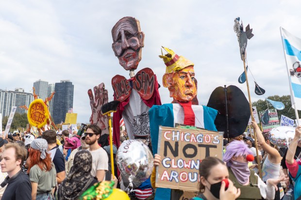 Demonstrators with large puppets attend the "No Kings" rally at Butler Field in Grant Park, Oct. 18, 2025, in Chicago. (Peter Tsai/Chicago Tribune)
