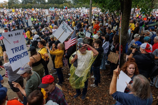 People gather while attending a No Kings rally in Grant Park in response to President Donald Trump's increased immigration enforcement actions in the area Saturday Oct. 18, 2025. (Armando L. Sanchez/Chicago Tribune)