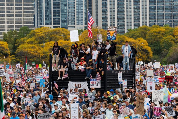 People gather while attending a No Kings rally in Grant Park in response to President Donald Trump's increased immigration enforcement actions in the area Saturday Oct. 18, 2025 in Chicago. (Armando L. Sanchez/Chicago Tribune)