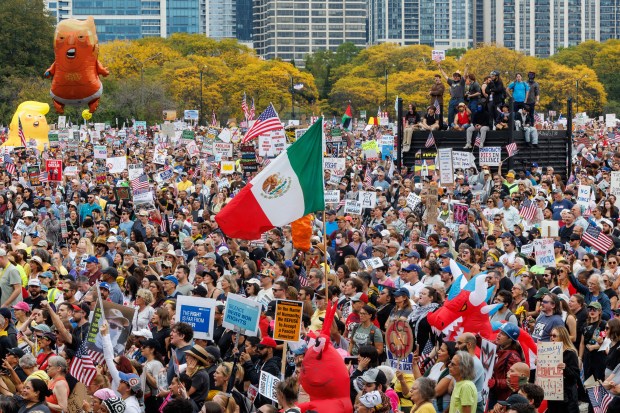 People gather while attending a No Kings rally in Grant Park in response to President Donald Trump's increased immigration enforcement actions in the area, Oct. 18, 2025 in Chicago. (Armando L. Sanchez/Chicago Tribune)