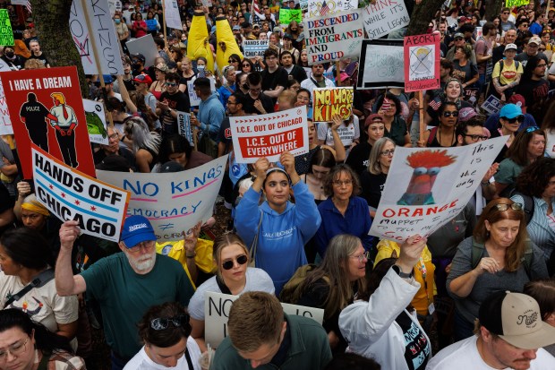 People gather while attending a No Kings rally in Grant Park on Oct. 18, 2025, in Chicago. (Armando L. Sanchez/Chicago Tribune)
