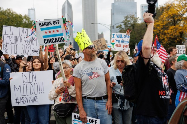 People gather while attending a No Kings rally in Grant Park on Oct. 18, 2025 in Chicago. (Armando L. Sanchez/Chicago Tribune)