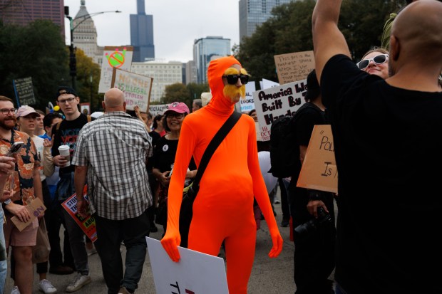 People gather while attending a No Kings rally in Grant Park in response to President Donald Trump's increased immigration enforcement actions in the area Saturday Oct. 18, 2025 in Chicago. (Armando L. Sanchez/Chicago Tribune)
