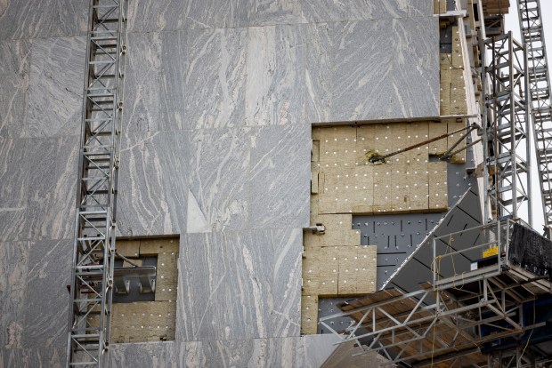 Granite panels are installed as construction continues on the tower at the Obama Presidential Center on June 2, 2025, in Jackson Park. (Brian Cassella/Chicago Tribune)