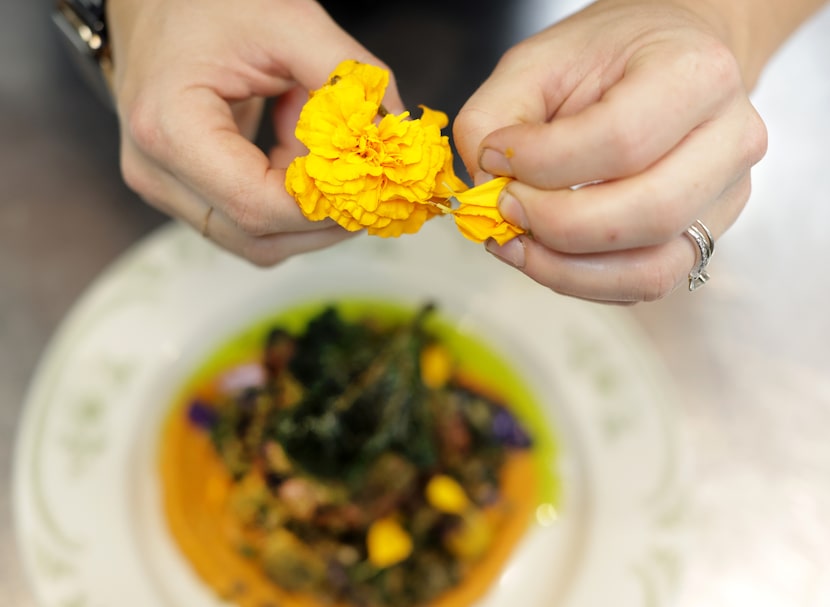 Executive chef Andrea Shackelford adds the final touches to a dish at 2024 Michelin...