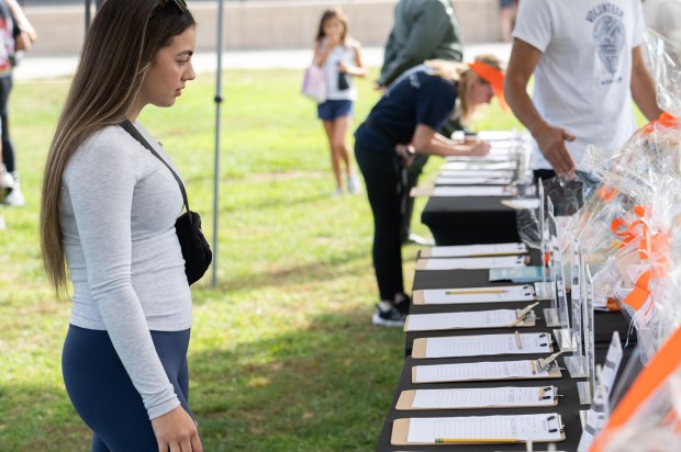 Jade Lancaster looks at the silent auction items (Jon Clark)