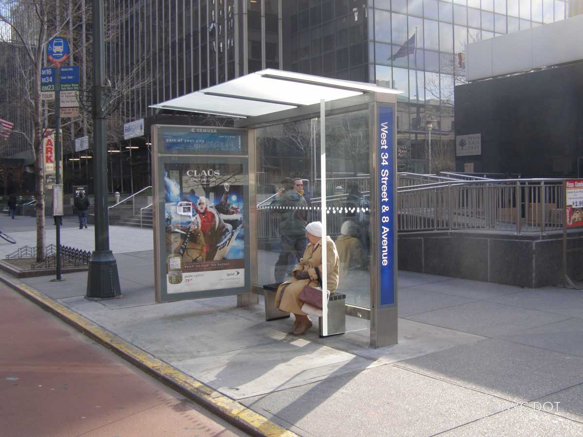 Take a seat! Thousands of NYC bus stops to get outfitted with new benches or leaning bars through $40 million investment 1 a woman sitting on a bench at a one of the NYC bus stops in the city