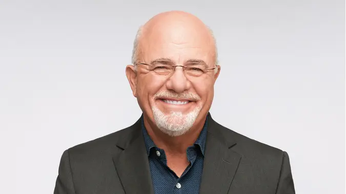 Dave Ramsey smiling at the camera, wearing a suit
