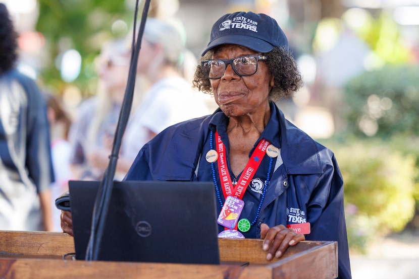 State Fair of Texas employee Faye Thomas, 87, waits to greet fairgoers and scan their...