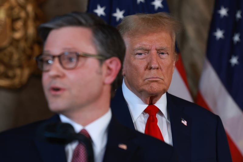 Donald Trump listens as Speaker of the House Mike Johnson (R-LA) speaks during a press conference at Mr. Trump's Mar-a-Lago estate on April 12, 2024, in Palm Beach, Florida.