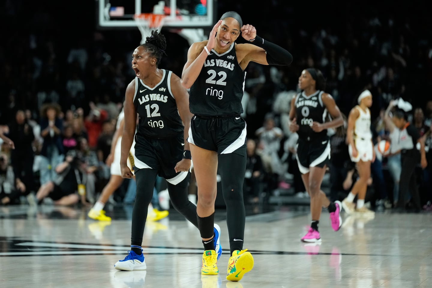Aces center A'ja Wilson (22) and guard Chelsea Gray (12) celebrate during their Game 5 win over Indiana Tuesday night in Las Vegas.