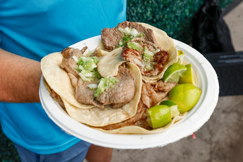 Drew Stephenson shows of his taco plate at an El Califa de León taquería pop-up, Thursday,...