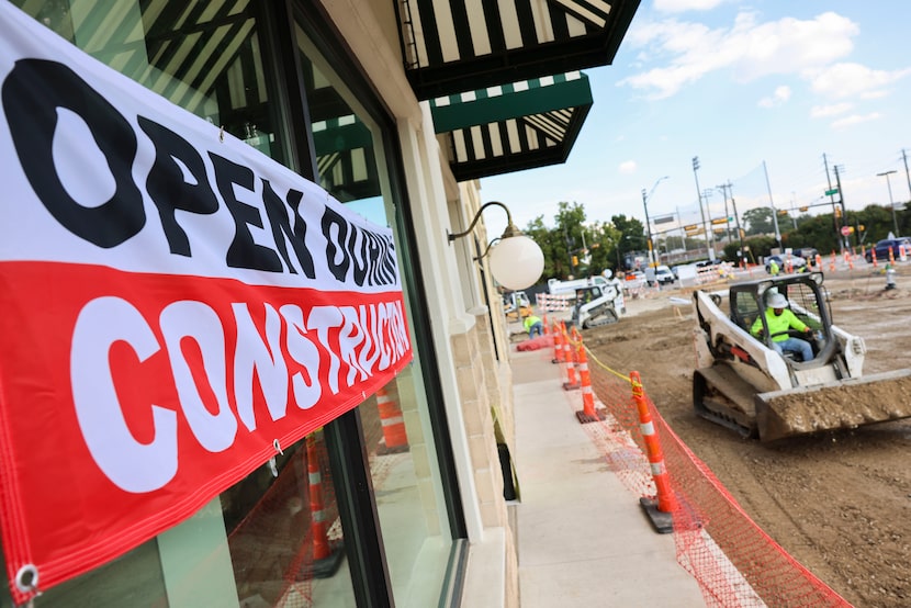 Open sign remain outside the businesses along Lovers Ln. in a construction site, on Tuesday,...