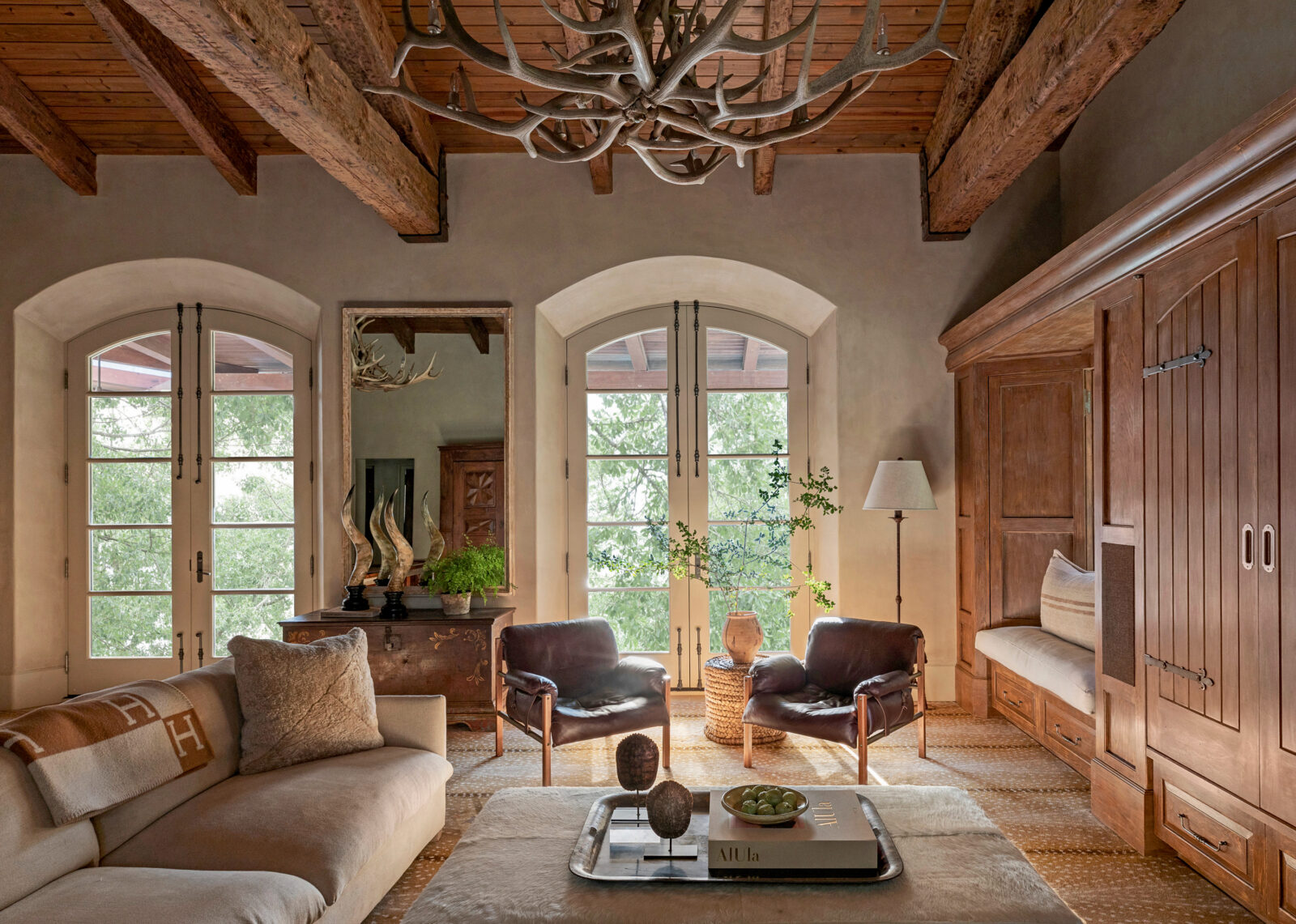 An elf antler chandelier anchors a living room