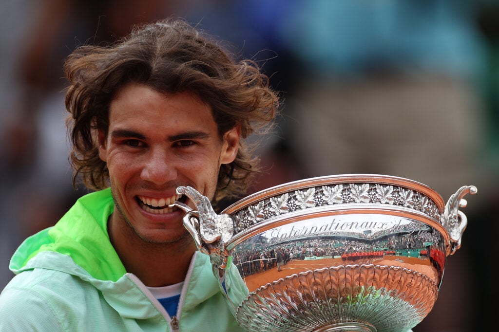 Rafael Nadal bites the trophy after winning the 2010 French Open