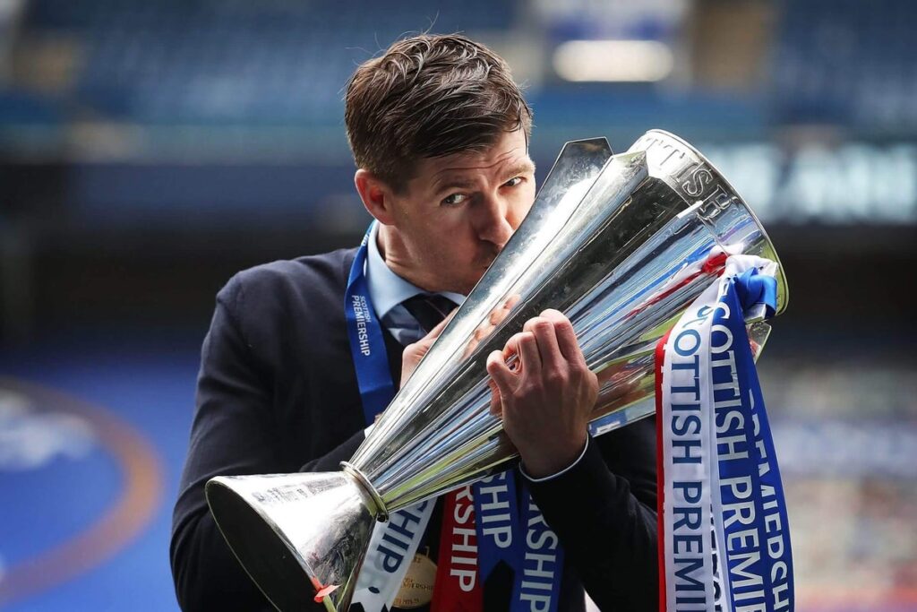Rangers Manager Steven Gerrard is seen kissing the trophy during the Scottish Premiership match between Rangers and Aberdeen on May 15, 2021 in Glasgow, Scotland. Sporting stadiums around the UK remain under strict restrictions due to the Coronavirus Pandemic as Government social distancing laws prohibit fans inside venues resulting in games being played behind closed doors.