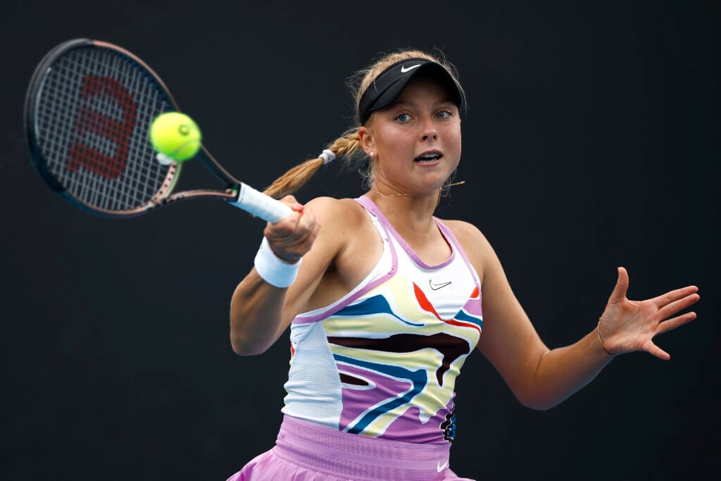 Brenda Fruhvirtova of the Czech Republic plays a forehand in their round one singles match against Aliaksandra Sasnovich during day one of the 2023 Australian Open at Melbourne Park.