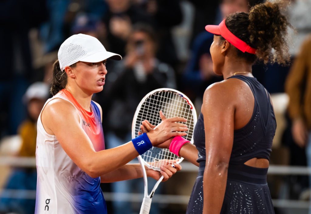 Iga Swiatek and Naomi Osaka shake hands at the 2024 French Open.