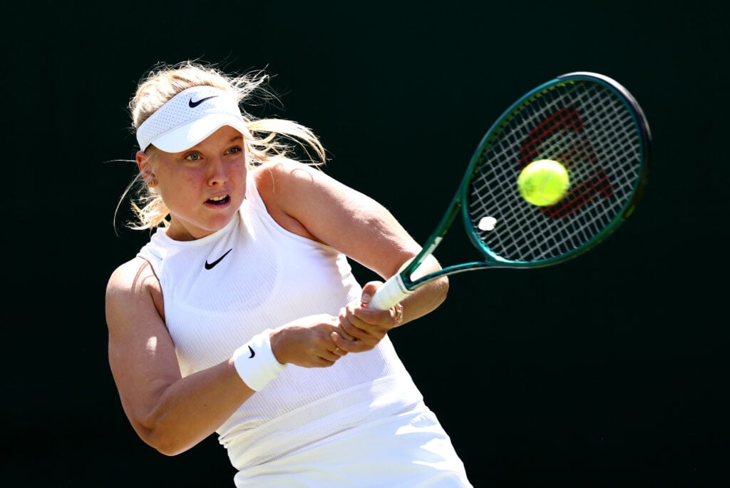 Brenda Fruhvirtova of Czechia plays a backhand against Paula Badosa of Spain in her Ladies' Singles second round match during day four of The Championships Wimbledon 2024 at All England Lawn Tennis and Croquet Club.