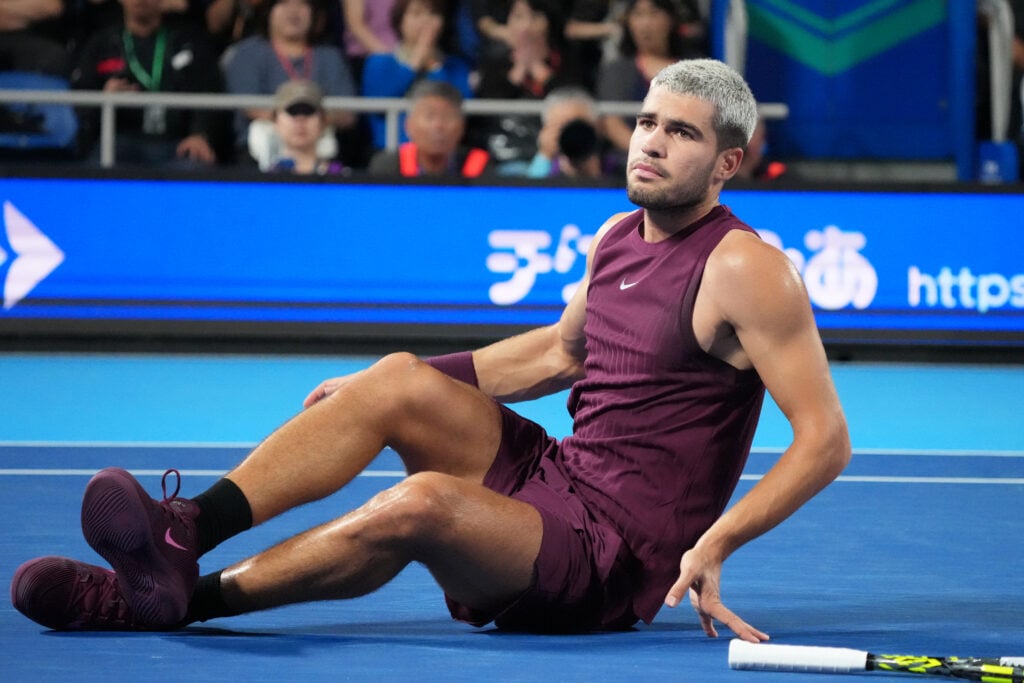 Carlos Alcaraz reacts after injuring his ankle at the 2025 Japan Open
