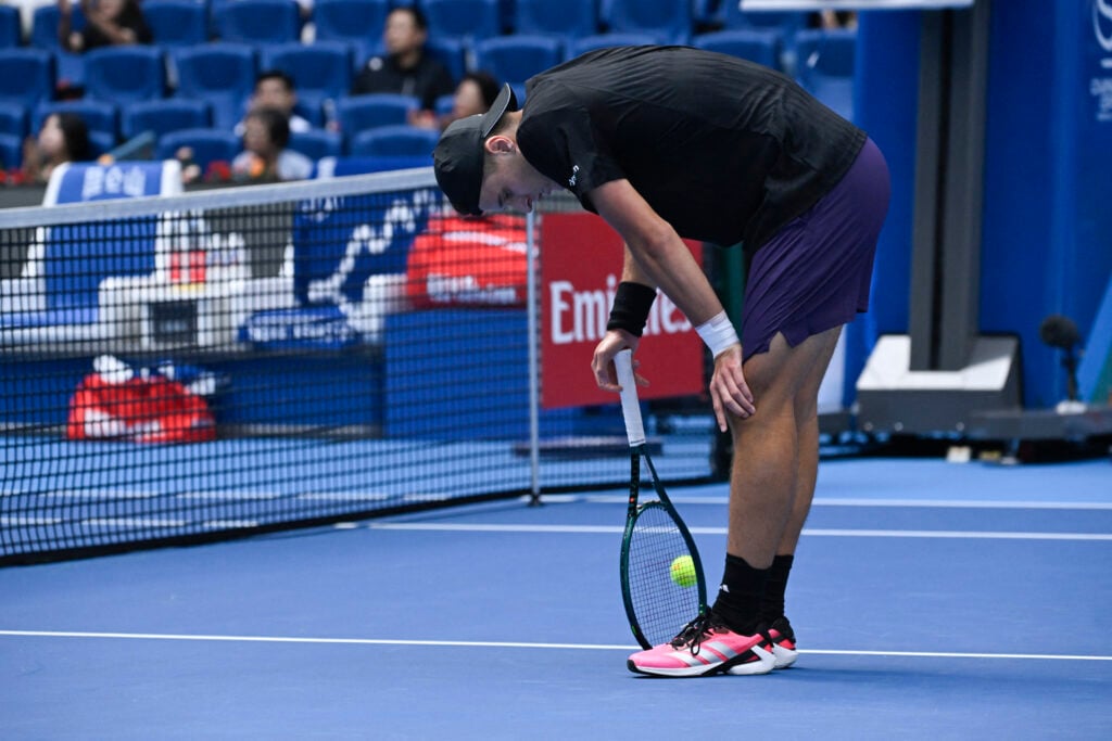 Jakub Mensik reacts during his men's singles match against Australia's Alex De Minaur at the China Open tennis tournament in Beijing.